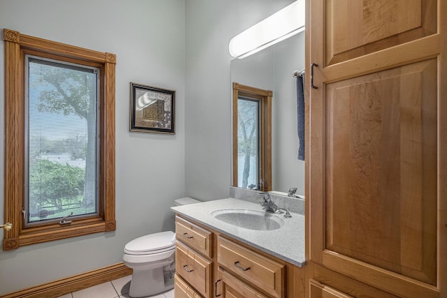 bathroom featuring tile patterned flooring, vanity, and toilet