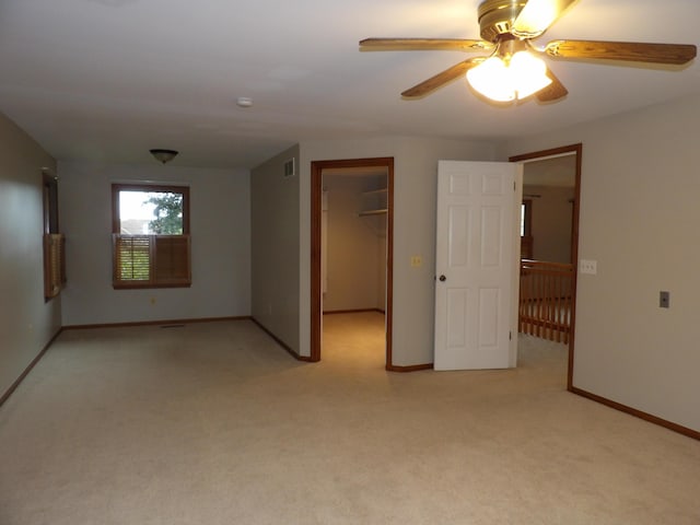 empty room with light carpet and ceiling fan