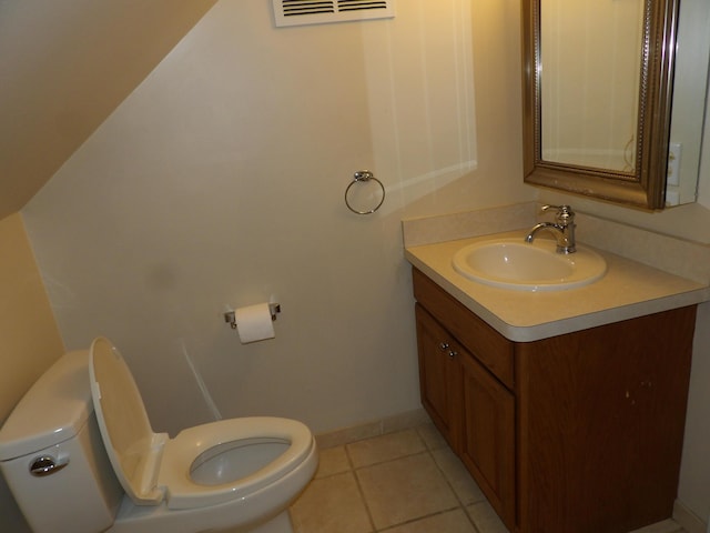 bathroom with tile patterned flooring, vanity, and toilet