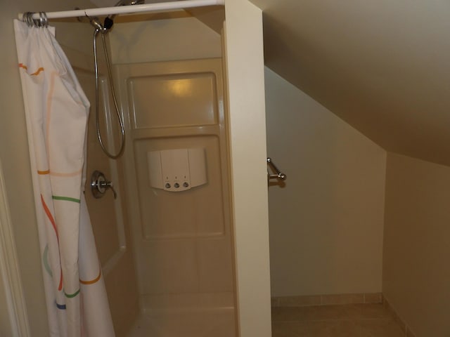 bathroom with tile patterned floors and curtained shower