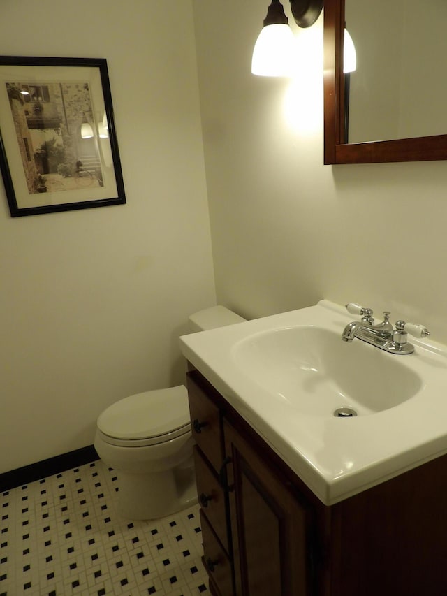 bathroom featuring tile patterned floors, vanity, and toilet