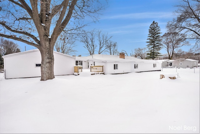 view of snow covered back of property