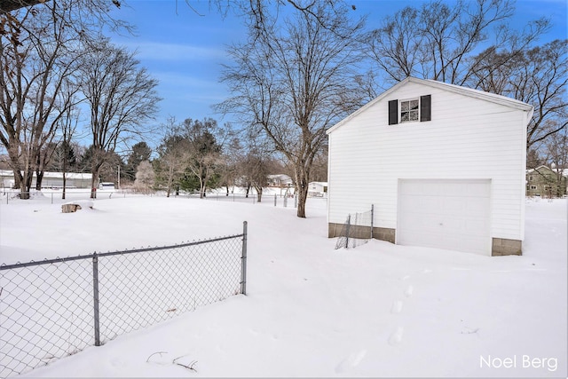 yard layered in snow with a garage