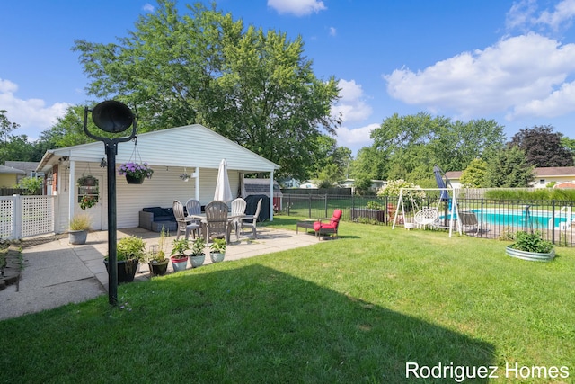 view of yard featuring a patio, a playground, and a fenced in pool