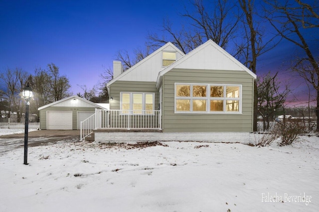 view of front of property featuring a garage and an outdoor structure