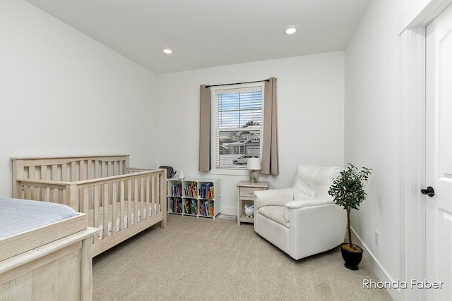 bedroom with light colored carpet and a crib