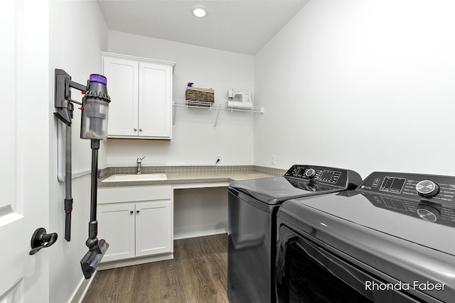 laundry room with cabinets, washing machine and dryer, sink, and dark wood-type flooring