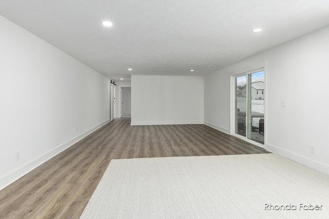 interior space with dark hardwood / wood-style floors and a textured ceiling