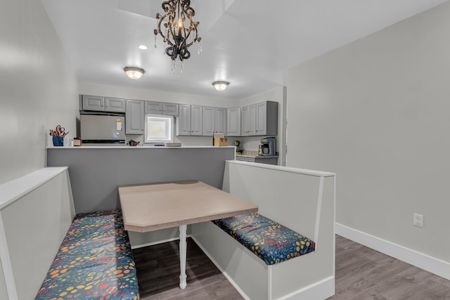 dining space featuring light hardwood / wood-style flooring and a notable chandelier