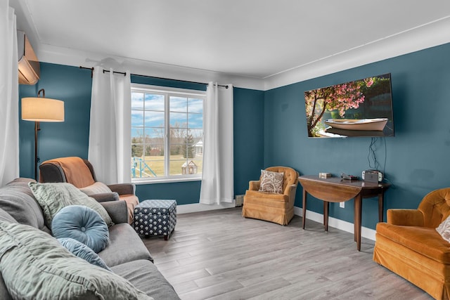 living area with hardwood / wood-style floors and a wall unit AC