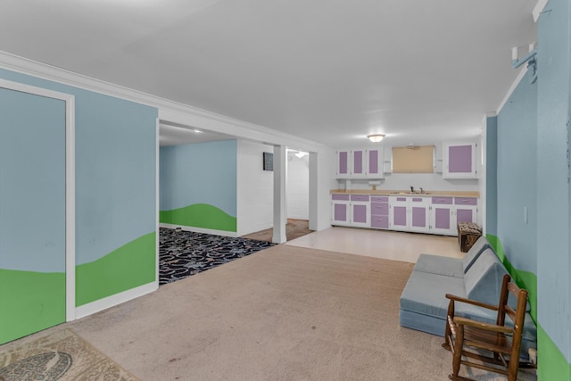 living area featuring light carpet, sink, and ornamental molding