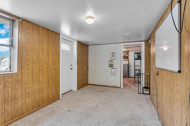 carpeted spare room with wood walls