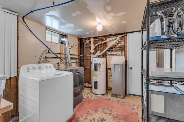 clothes washing area featuring independent washer and dryer and water heater