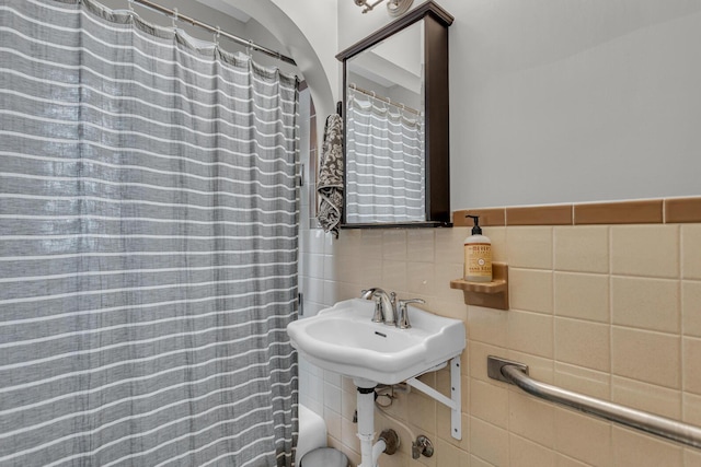 bathroom with tile walls