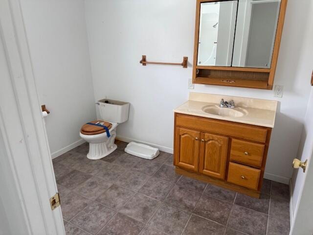 bathroom featuring tile patterned floors, vanity, and toilet