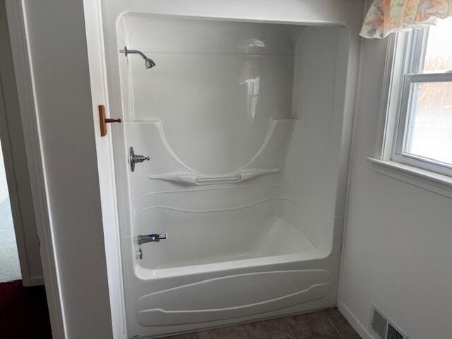 bathroom featuring tile patterned flooring and bathtub / shower combination