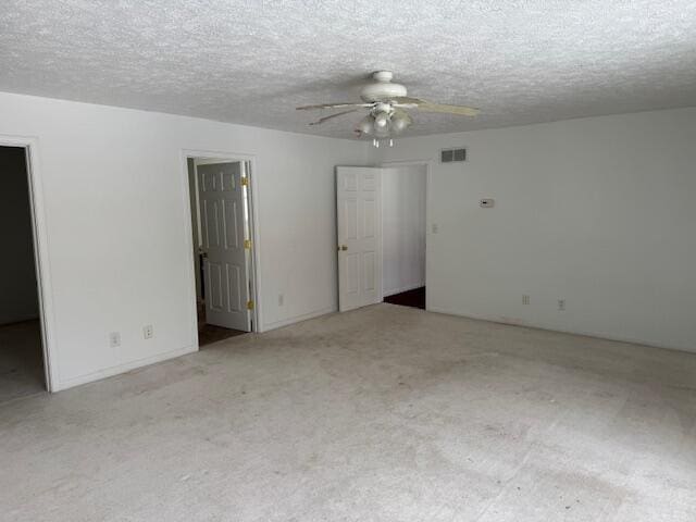 carpeted empty room featuring a textured ceiling and ceiling fan