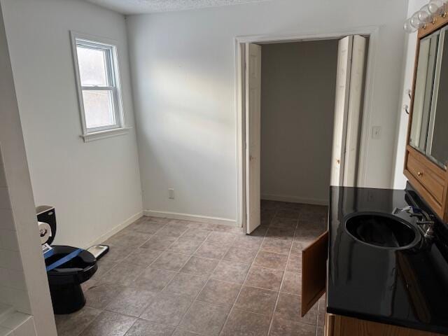 washroom featuring light tile patterned floors and sink