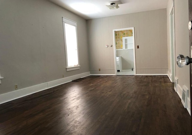 spare room featuring dark hardwood / wood-style flooring