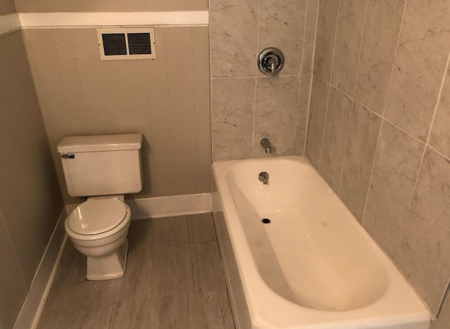 bathroom with toilet and a bathing tub