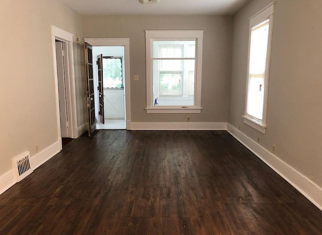 spare room with dark wood-type flooring