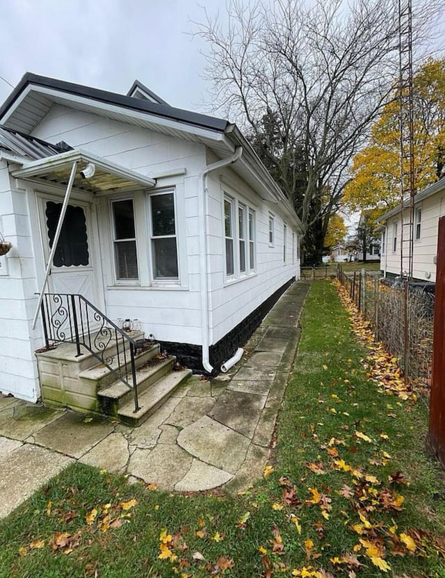 view of side of home featuring a yard