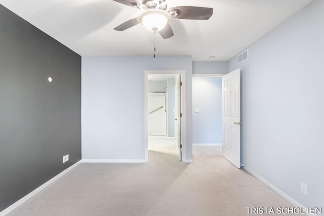 carpeted empty room with ceiling fan