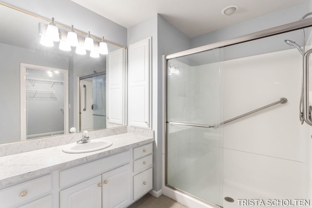 bathroom with vanity and a shower with shower door