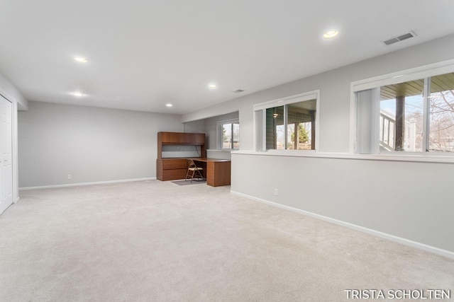 unfurnished living room with light carpet