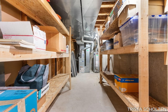 storage area featuring heating unit and water heater