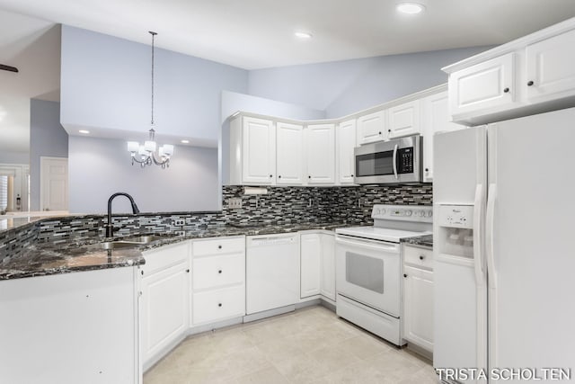 kitchen with white cabinets, white appliances, hanging light fixtures, and sink