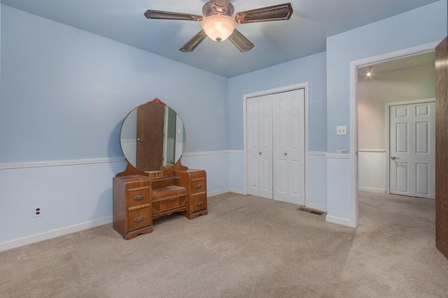 carpeted bedroom with ceiling fan and a closet