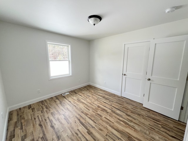 unfurnished bedroom with wood-type flooring