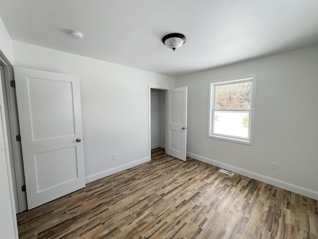 unfurnished bedroom featuring hardwood / wood-style floors