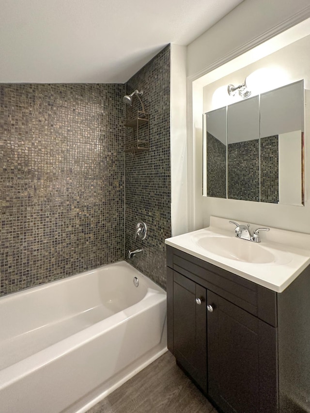 bathroom with vanity, tiled shower / bath combo, and hardwood / wood-style flooring