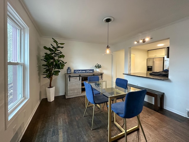 dining room featuring dark hardwood / wood-style flooring and ornamental molding