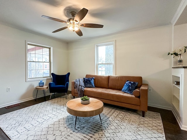 living room with hardwood / wood-style flooring, ceiling fan, a healthy amount of sunlight, and ornamental molding