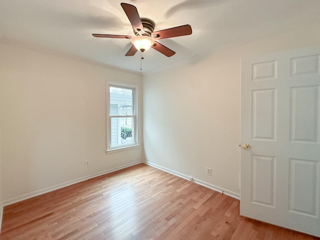 empty room with ceiling fan, crown molding, and light hardwood / wood-style floors