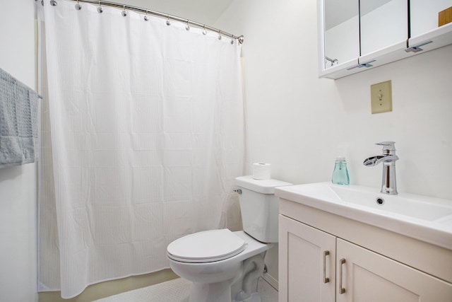 bathroom with tile patterned flooring, vanity, and toilet