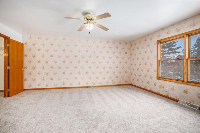 spare room with carpet flooring and ceiling fan