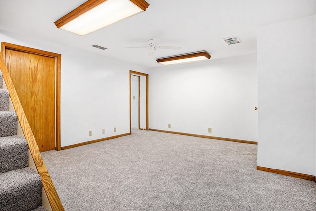 unfurnished room featuring light colored carpet and ceiling fan