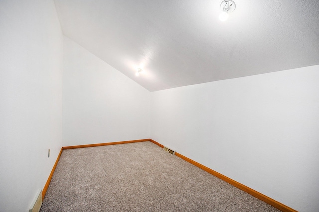 bonus room featuring lofted ceiling and carpet floors