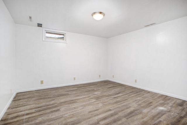 spare room with hardwood / wood-style floors