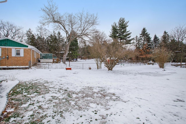 view of yard layered in snow