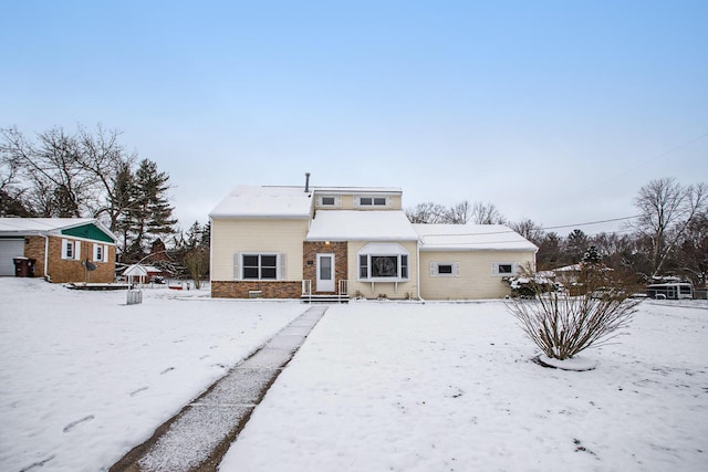 view of snow covered rear of property