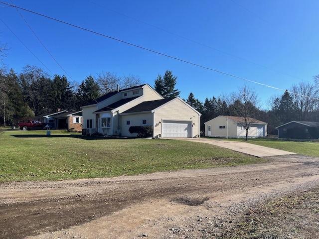 view of side of property with a garage and a lawn