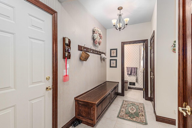 interior space with light tile patterned flooring and an inviting chandelier