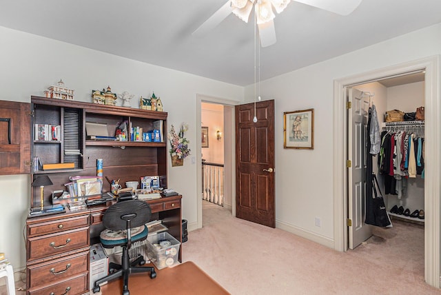 office space featuring ceiling fan and light carpet