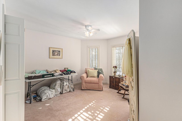 bedroom featuring ceiling fan and light carpet