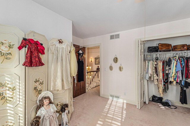 bedroom with light colored carpet and a closet